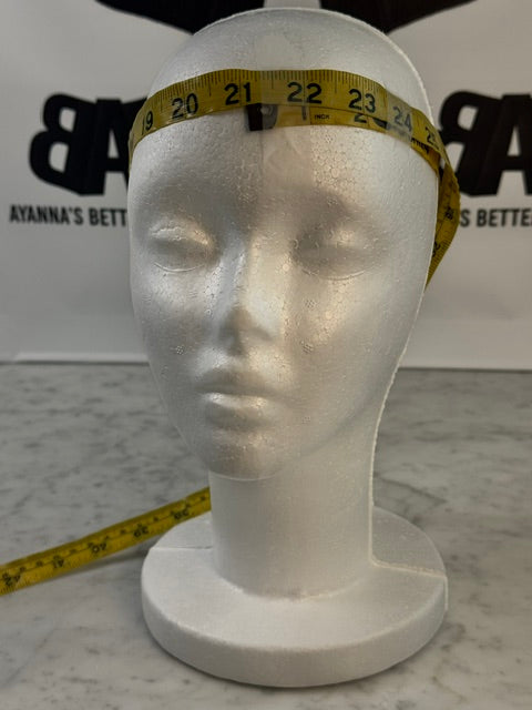 Small styrofoam mannequin head measuring approximately 21-23 inches in circumference, showing headwrap sizing reference