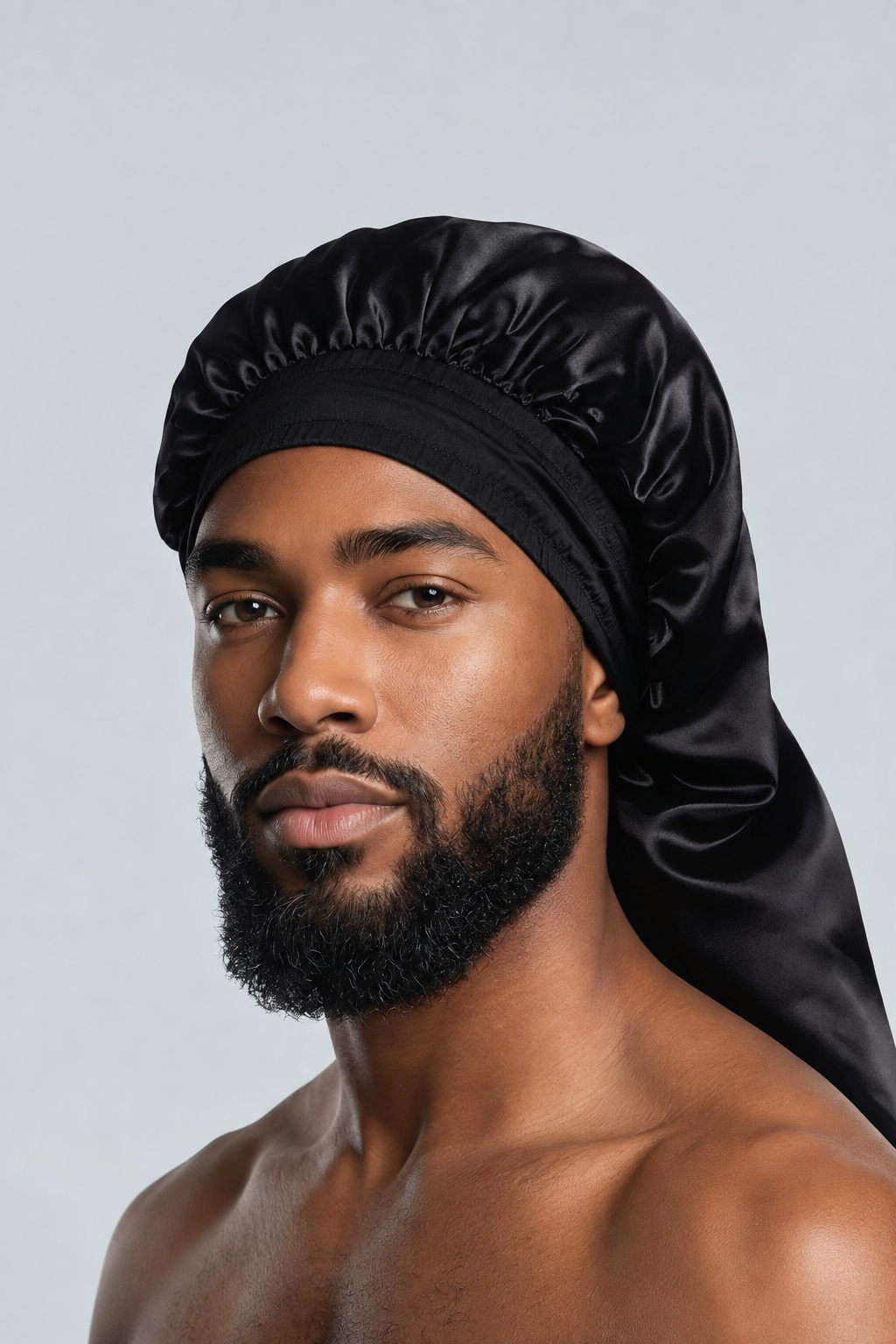 Male model in black satin bonnet without visible bow or ties
