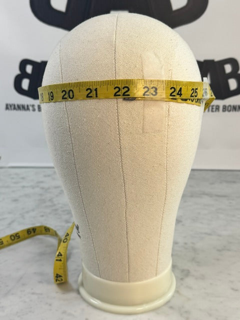 Large canvas mannequin head measuring approximately 22-25 inches in circumference, showing headwrap sizing reference