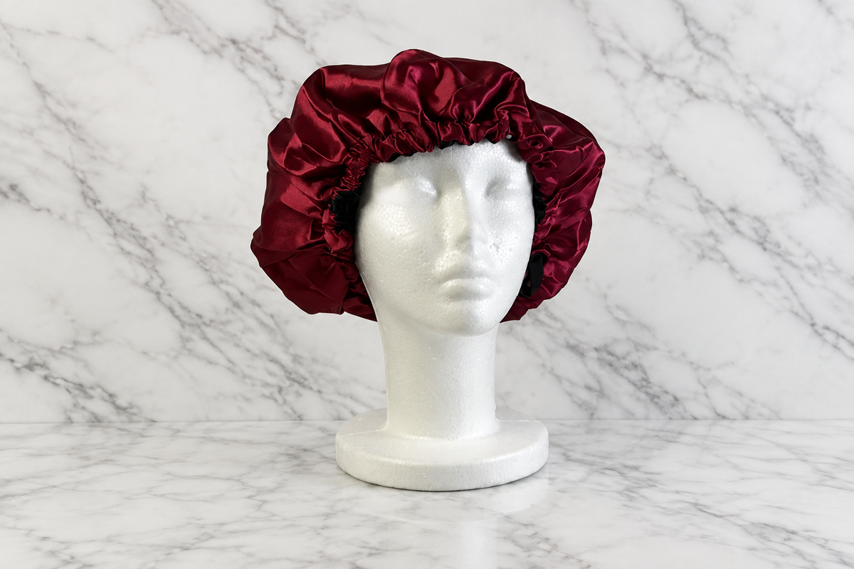 Maroon and black bonnet on white marble