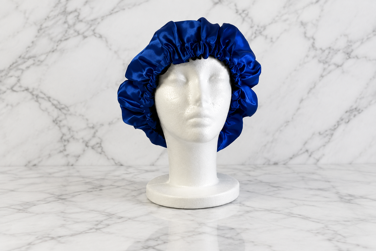 Royal blue and black bonnet on white marble